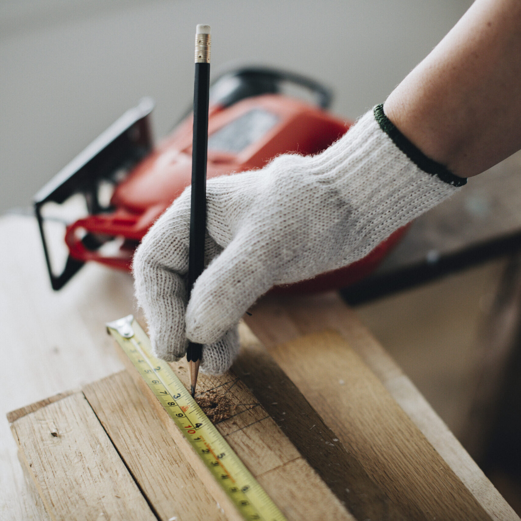 woman-measuring-wooden-plank
